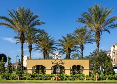 a hotel with palm trees in the background at Vista Cay Resort by Millenium at Universal Blvd. in Orlando