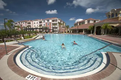 a group of people swimming in a swimming pool at Vista Cay Resort by Millenium at Universal Blvd. in Orlando
