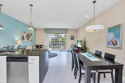 a kitchen and dining room with a table and chairs at 3 bed Town Home With Splash Pool! townhouse in Orlando