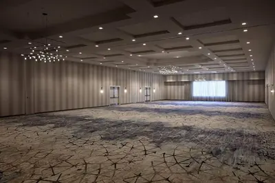 an empty ballroom with a large room with a stage at Marriott Orlando Downtown in Orlando