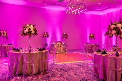 a purple room with two tables and chairs in it at Marriott Orlando Downtown in Orlando