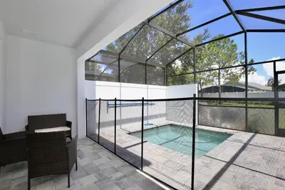 a glass house with a swimming pool inside at Great 4 bedroom townhouse in Hidden Forest, with private pool! in Orlando