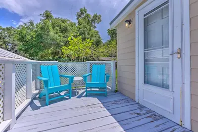 a pair of blue chairs sitting on a porch at 16 Mi to Disney Cottage with Deck in Winter Garden in Orlando