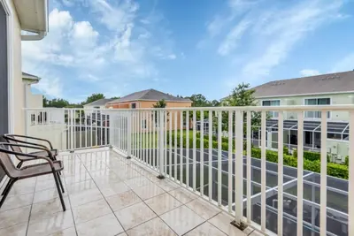 a balcony with a white fence and a chair at Serenity 3 Bed Townhome townhouse in Orlando