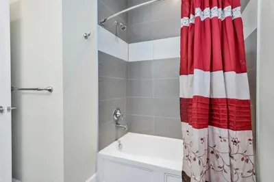 a bathroom with a red and white shower curtain at Serenity 3 Bed Townhome townhouse in Orlando