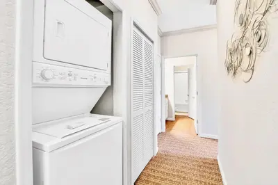 a white laundry room with a washer and dryer at Modern 3BR - Near Disney - Pool in Orlando
