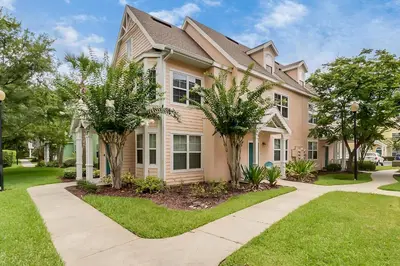 a house with trees in front of it at Cozy Apartment Only Miles From Disney Community Pool And Jacuzzii in Kissimmee
