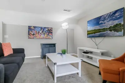 a living room with a couch and a table at Cozy Apartment Only Miles From Disney Community Pool And Jacuzzii in Kissimmee