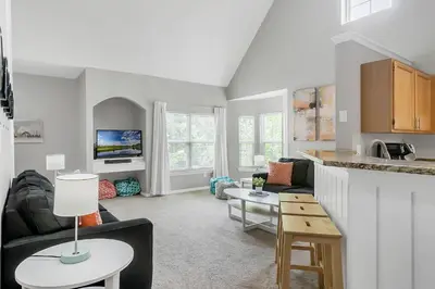 a living room with a couch and a table at Cozy Apartment Only Miles From Disney Community Pool And Jacuzzii in Kissimmee