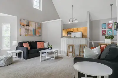 a living room with a couch and a table at Cozy Apartment Only Miles From Disney Community Pool And Jacuzzii in Kissimmee