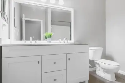 a white bathroom with a sink and a toilet at Cozy Apartment Only Miles From Disney Community Pool And Jacuzzii in Kissimmee
