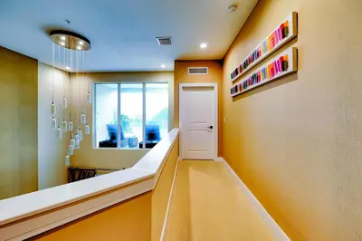 a hallway with a door and a mirror in a room at Beautiful Townhome Overlooking The Lake And The Pool in Orlando