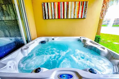 a jacuzzi tub in front of a window at Beautiful Townhome Overlooking The Lake And The Pool in Orlando