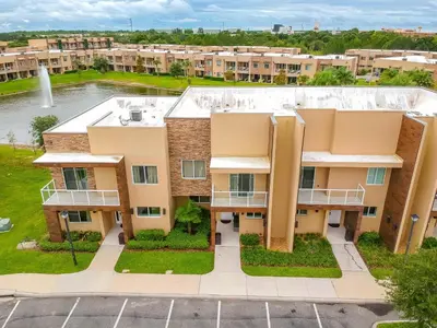 an aerial view of an apartment building with a fountain at Beautiful Townhome Overlooking The Lake And The Pool in Orlando
