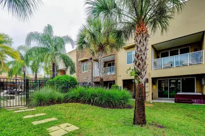 a palm tree in front of a building at Beautiful Townhome Overlooking The Lake And The Pool in Orlando
