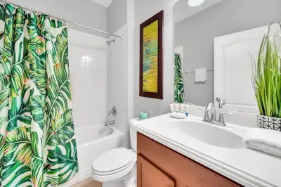 a bathroom with a sink and a toilet and a shower curtain at Appealing, Large 5BD Home Close to Themed-Parks #5PP961 in Kissimmee