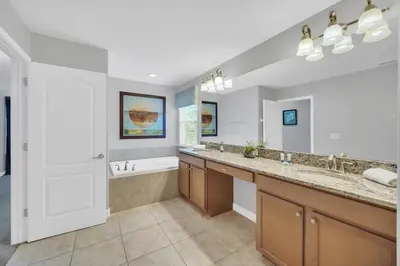 a bathroom with two sinks and a tub and a shower at Appealing, Large 5BD Home Close to Themed-Parks #5PP961 in Kissimmee