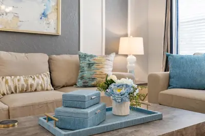 a living room with a couch and a vase of flowers at Spacious 6BR Villa Pool Parking Near Disney World in Orlando