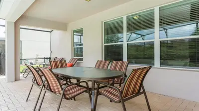 a dining room with a table and chairs at Spacious 6BR Villa with Pool SPA 3 Miles to Disney in Orlando