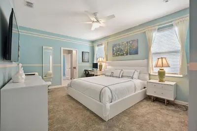 a bedroom with a white bed and blue walls at Luxury Villa near Disney 8 Bedroom Private Pool & Playground1 in Kissimmee