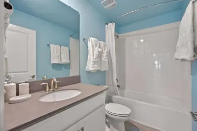 a bathroom with a sink and a toilet and a shower at Luxury Villa near Disney 8 Bedroom Private Pool & Playground1 in Kissimmee