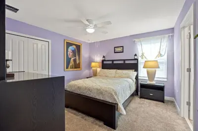 a bedroom with a bed and a ceiling fan at Luxury Villa near Disney 8 Bedroom Private Pool & Playground1 in Kissimmee