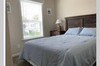 a bedroom with a large bed and a window at Resort Cottage near parks at Great Price! in Kissimmee