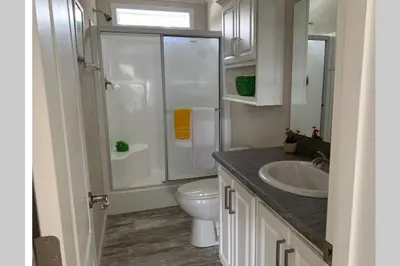 a bathroom with a white toilet and a sink at Resort Cottage near parks at Great Price! in Kissimmee