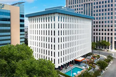 an aerial view of a white building with a pool at Aloft Orlando Downtown in Orlando