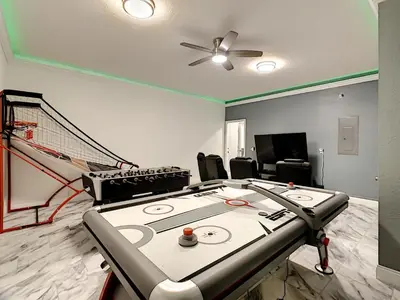 a ping pong table in a room with a net at Luxury Family Villa Pool Hot Tub Close to Disney in Orlando