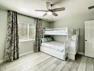 a bedroom with a bunk bed and a ceiling fan at Luxury Family Villa Pool Hot Tub Close to Disney in Orlando