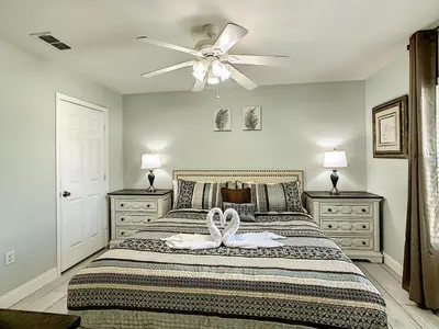 a bedroom with a bed with a ceiling fan at Luxury Family Villa Pool Hot Tub Close to Disney in Orlando