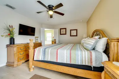 a bedroom with a bed and a ceiling fan at Spacious Kissimmee Family Home with Game Room and Pool in Kissimmee