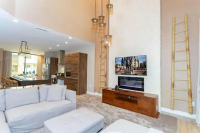 a living room with a white couch and a tv at Gorgeous 4Bd Close to Disney @ Magic Village 7581 in Orlando