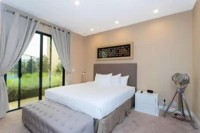 a bedroom with a large white bed and a window at Gorgeous 4Bd Close to Disney @ Magic Village 7581 in Orlando