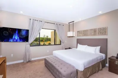 a bedroom with a large bed and a window at Gorgeous 4Bd Close to Disney @ Magic Village 7581 in Orlando