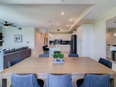 a dining room and living room with a table and chairs at Cute Lakeview 2BR Condo with 2 Clubhouses in Kissimmee