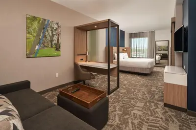 a hotel room with a couch and a bedroom at SpringHill Suites by Marriott Winter Park in Orlando