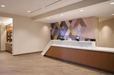 a lobby of a pharmacy with a reception counter at SpringHill Suites by Marriott Winter Park in Orlando