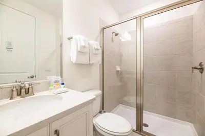 a bathroom with a shower and a toilet and a sink at Sky Blue Cottage With Private Pool Near Disney With Margaritaville Resort & Island H2O Access - 8045Kd in Orlando