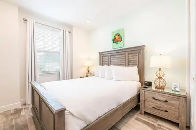 a bedroom with a large bed and a window at Sky Blue Cottage With Private Pool Near Disney With Margaritaville Resort & Island H2O Access - 8045Kd in Orlando