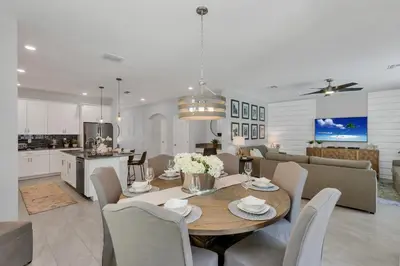 a dining room and kitchen with a table and chairs at Lovely Private Pool Villa wFREE Resort Access in Kissimmee