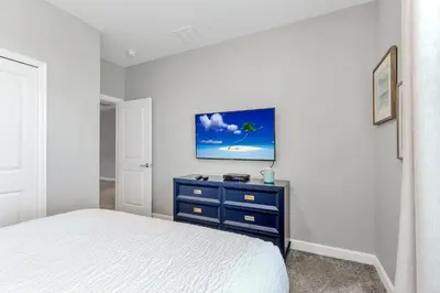 a bedroom with a bed and a blue dresser at Lovely Private Pool Villa wFREE Resort Access in Kissimmee