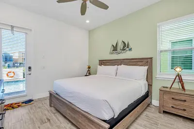 a bedroom with a bed and a ceiling fan at Margaritaville Cottage, PRIVATE POOL, Near Disney in Orlando