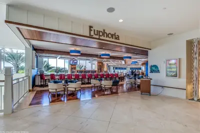 a restaurant with red chairs and tables in a building at Margaritaville Cottage, PRIVATE POOL, Near Disney in Orlando