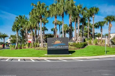 a sign on the side of a road with palm trees at 8044 Sandy Toes Way in Orlando