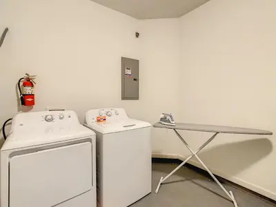 a laundry room with a washing machine and a table at Stylish Vista Cay Townhome Near Conv. Ctr I-Dr. in Orlando