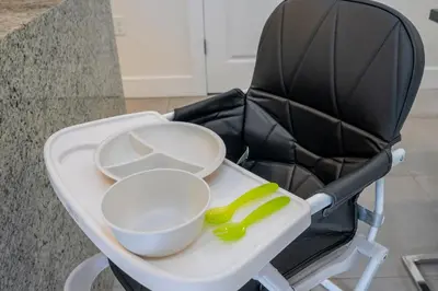 a high chair with a bowl and a spoon at Themed Disney House 5 min to Disney Parks, Heated Pool, Jacuzzi, Gym and more in Orlando