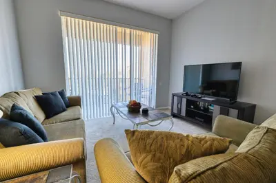 a living room with two couches and a flat screen tv at Windsor Hills Resort 3 Bedroom Condo 5 Minutes to Disney in Orlando