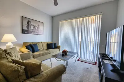 a living room with a couch and a tv at Windsor Hills Resort 3 Bedroom Condo 5 Minutes to Disney in Orlando